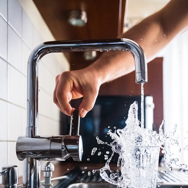 person opening faucet